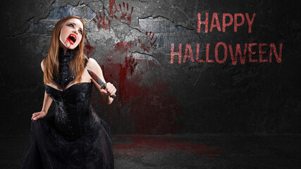 female vampire with a knife and the message HAPPY HALLOWEEN in front of a bloody wall - obrazy, fototapety, plakaty