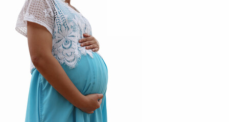 Pregnant woman in a blue dress isolated on white background.