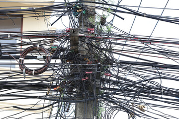 Cable wires on the electric poles are tangled,Messy signal line.