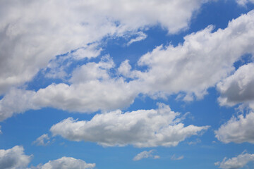 Blue sky with white clouds in the daytime background.