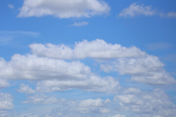 Blue sky with white clouds in the daytime background.