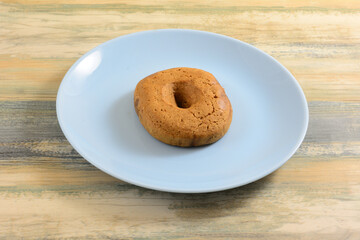 One Greek grape must moustokouloura soft cookie on blue snack plate