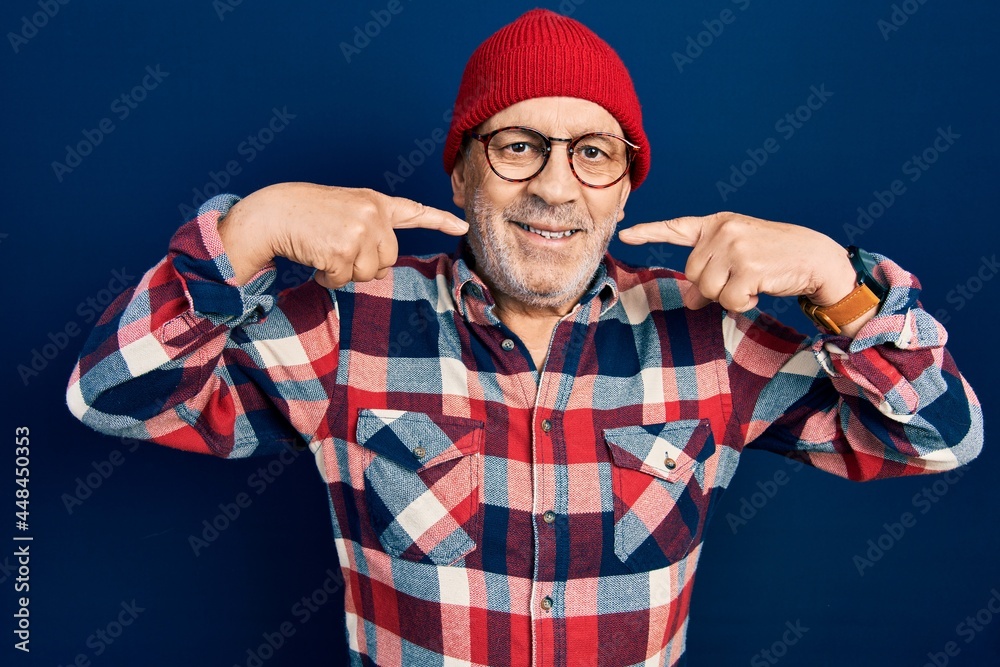 Poster Handsome mature man wearing hipster look with wool cap smiling cheerful showing and pointing with fingers teeth and mouth. dental health concept.