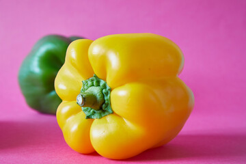 Sweet pepper. Yellow, green and bell pepper on fuchsia and light blue background.