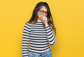 Young beautiful teen girl wearing casual clothes and glasses feeling unwell and coughing as symptom...