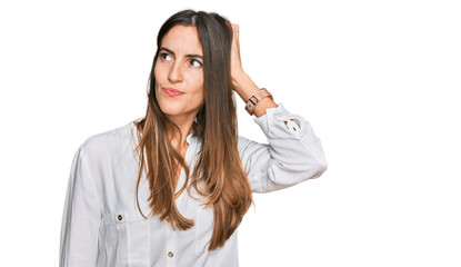 Young beautiful woman wearing casual clothes confuse and wondering about question. uncertain with...