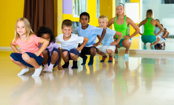 Positive little boys and beautiful girls having dancing class. High quality photo