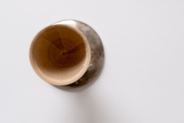 isolated wooden object-cup with metal ring on white