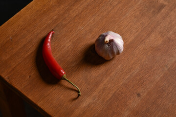 red hot chili pepper and garlic on wooden background