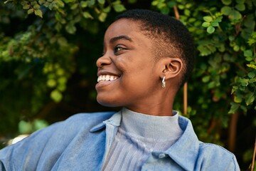 Young african american woman smiling happy standing at the park.