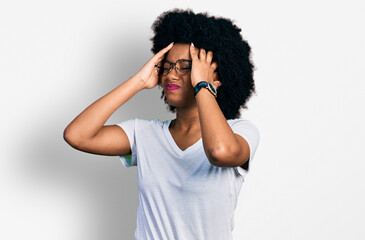 Fototapeta na wymiar Young african american woman wearing casual white t shirt suffering from headache desperate and stressed because pain and migraine. hands on head.