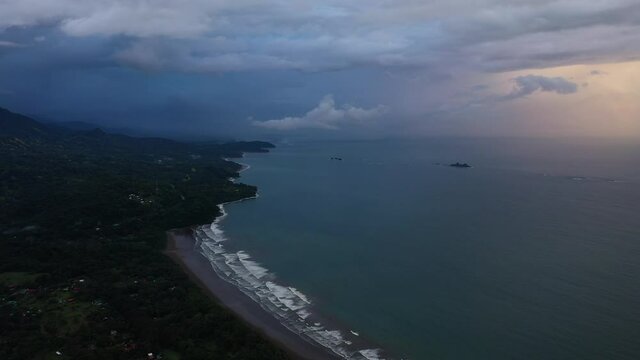 view of the pacific ocean coastline from above Costa Rica mountains and stormy sunset aerial