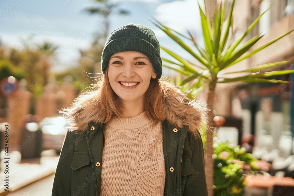 Sticker Young caucasian girl smiling happy standing at the city.