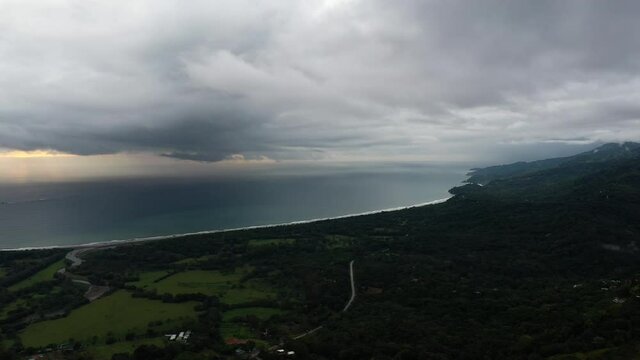 Mountains tropical forest along the pacific ocean aerial hermosa beach Costa Rica cloudy day 