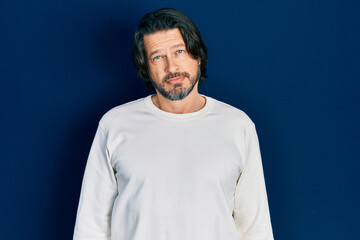 Middle age caucasian man wearing casual clothes relaxed with serious expression on face. simple and natural looking at the camera.