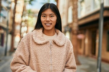 Young asian woman smiling happy standing at the city.