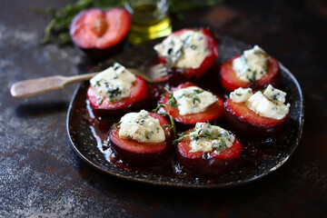 Baked plums with blue cheese and thyme. Healthy snack. Keto food. 