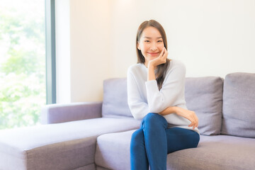 Portrait beautiful young asian woman relax smile on sofa