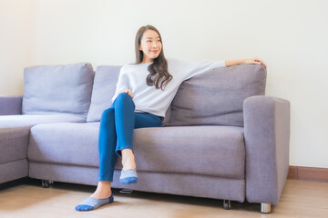 Portrait beautiful young asian woman relax smile on sofa