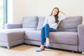 Fototapeta na wymiar Portrait beautiful young asian woman relax smile on sofa