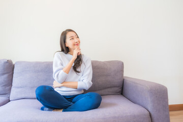 Portrait beautiful young asian woman relax smile on sofa