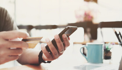 Online payment,Man's hands holding smartphone and using credit card for online shopping. Cyber Monday Concept