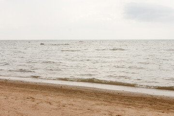 Fototapeta na wymiar Cloudy day at Baltic sea coast at Komarovo village near Saint Petersburg, Russia. Sandy shore.