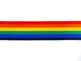 Rainbow stripe ribbon isolated on white background with copy space. LGBT concept with pride colors and rainbow flag strip. LGBT banner background.