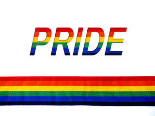 Pride, words and Rainbow stripe ribbon isolated on white background with copy space. LGBT concept with pride colors and rainbow flag strip. LGBT banner background.