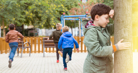 Kids playing hide and seek on the street. High quality photo