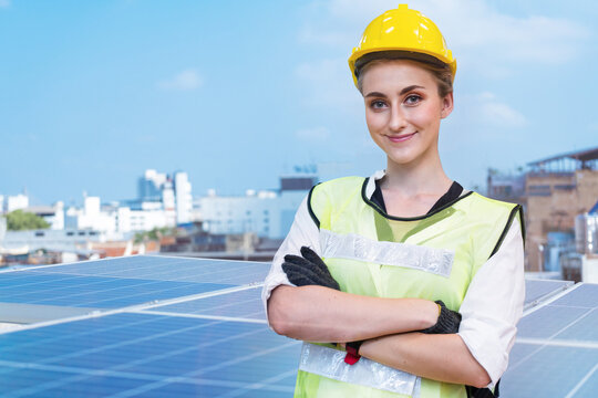 Engineer Woman Worker Is Standing With Confident At Team Engineer Man Inspects Construction Of Solar Cell Panel. Industrial Renewable Energy Of Green Power On Tower Roof.