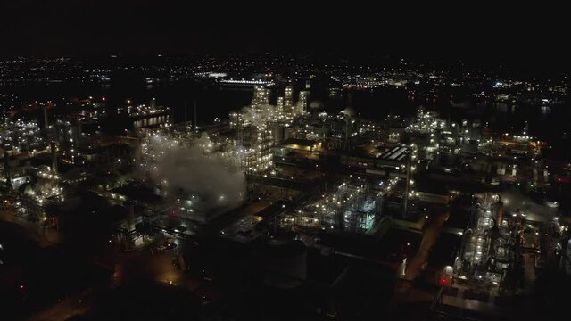 Lights And Smoke From Chemical Plant By The Embankment Of Beneden Merwede River In Dordrecht, Netherlands At Night. aerial