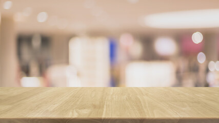 Empty wood table top on blur bokeh cafe and restaurant interior banner background - can be used for display or montage your products