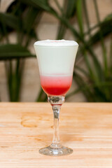 A colorful drink in a large glass cup