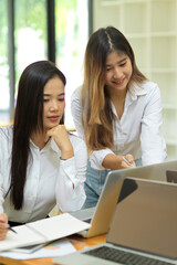 Beautiful businesswomen working via laptop