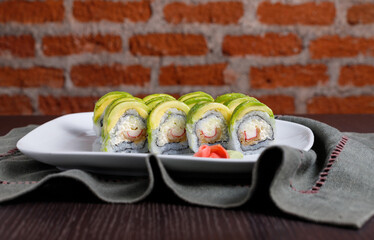 Sushi roll with avocado brick wall