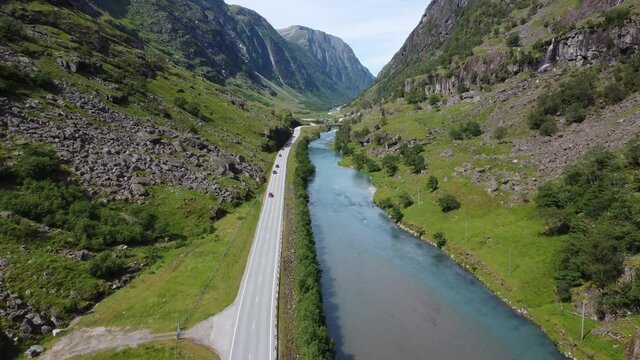 Lush mountain valley between Klagegg and Byrkjelo with road E39 passing through - River stardalselva with green color flowing beside road - Stardalen Sogn Norway