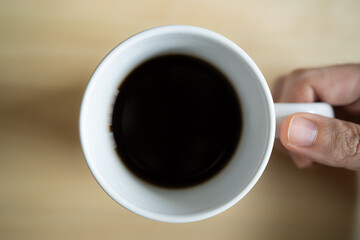 Black coffee in a white cup shot from above