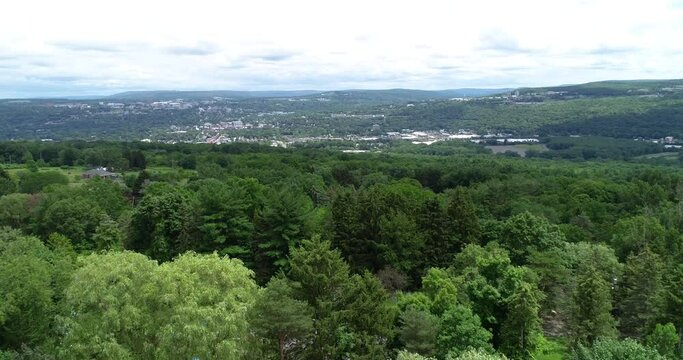 A lazy right dolly of the valley containing Ithaca New York with the college visible in the background.