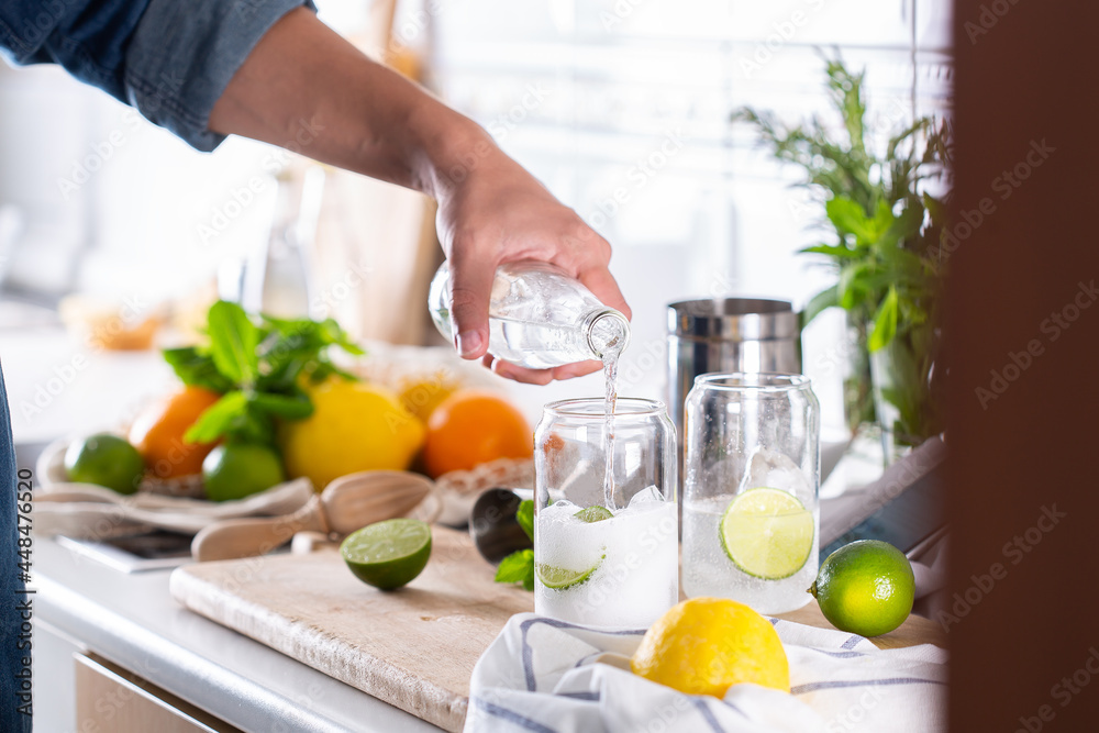 Canvas Prints Mixologist making refreshing cocktail with hard seltzer at home