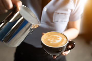 Baretta is making hot coffee in the shape of a heart in the morning.