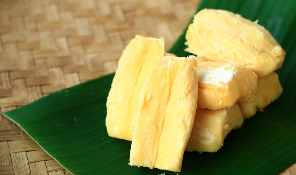 Fermented cassava or tape singkong on banana leaf. 