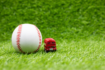 Baseball with double decker red bus in London , England