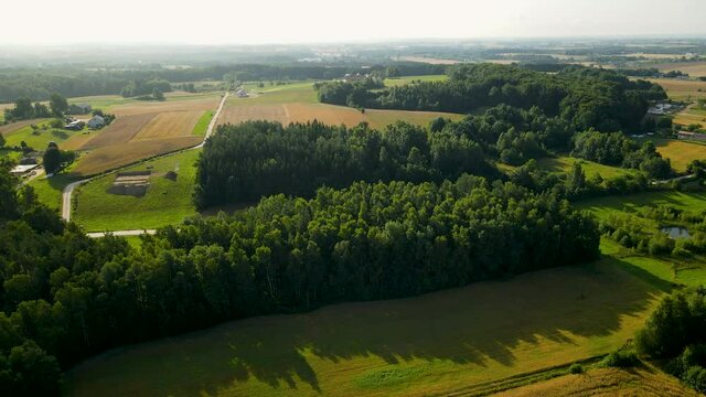 Stunning Countryside With Thicket Woods And Agricultural Terrain On A Misty Morning Near Czeczewo, Poland. - Aerial Shot