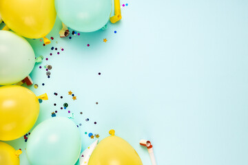 Colorful balloons and decoration party on blue background top view. Birthday greeting card flat lay