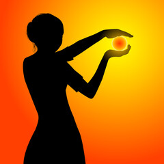 Young woman in dress holding the sun in her hands