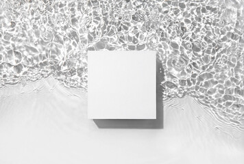 White square podium on the water surface background. Flat lay, copy space. 