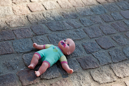 creepy and nasty doll lying on the ground