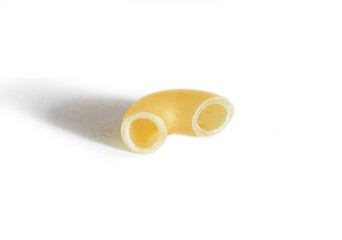 One macaroni isolated on a white background. Macro. Horn