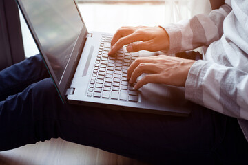 Hands of man working remotely at home, Man typing on laptop or computer